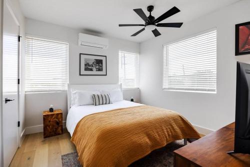 a bedroom with a bed and a ceiling fan at 5 Min to UT, Congress - Modern Home in DT East ATX in Austin