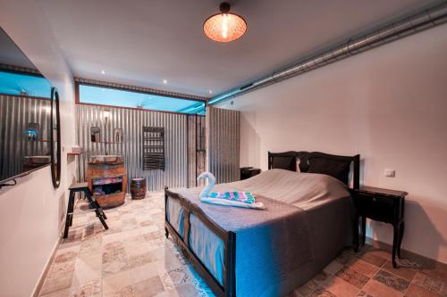 ein Schlafzimmer mit einem Bett und ein Zimmer mit einem Bad in der Unterkunft La Remise en Forme in Entraigues-sur-la-Sorgue