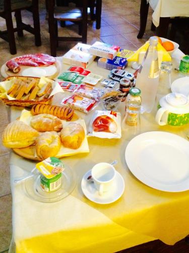 a table with food and drinks and plates on it at Castello Conti Filo in Torre Santa Susanna
