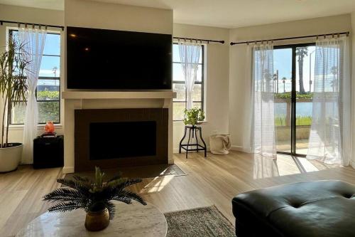 a living room with a flat screen tv above a fireplace at Beachfront Paradise in Port Hueneme