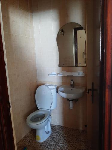 a bathroom with a toilet and a sink at Elhouda 56 in Agadir