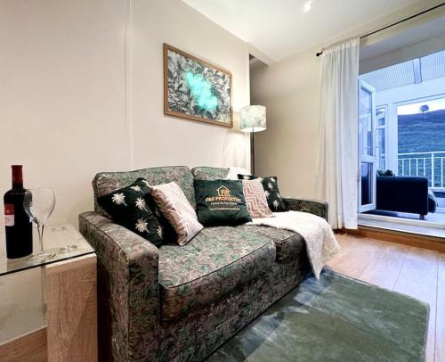 a living room with a couch and a window at Joyful Jungle Jewel w/Balcony & Foozeball-Ferndale 