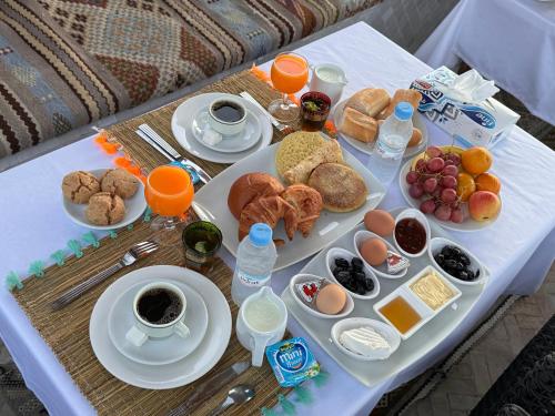 a table with a tray of breakfast foods and drinks at Riad Al-Qurtubi in Tangier