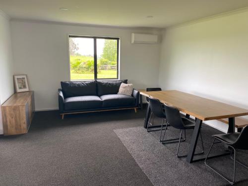 a living room with a table and a couch at peaceful and rural escape 