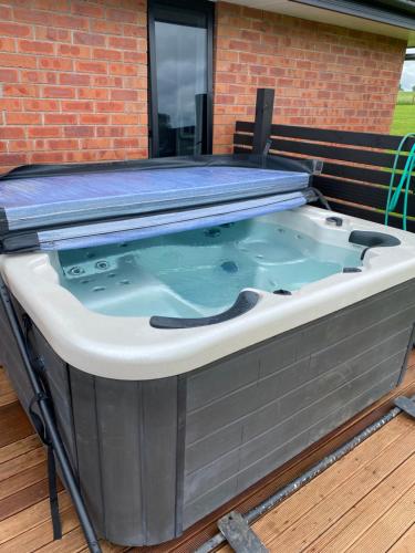 a large hot tub sitting on a deck at peaceful and rural escape 