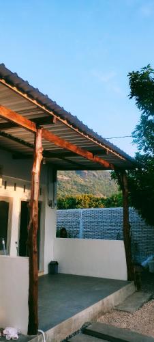 a wooden pergola on the side of a house at Scar Reef Homestay in Jereweh