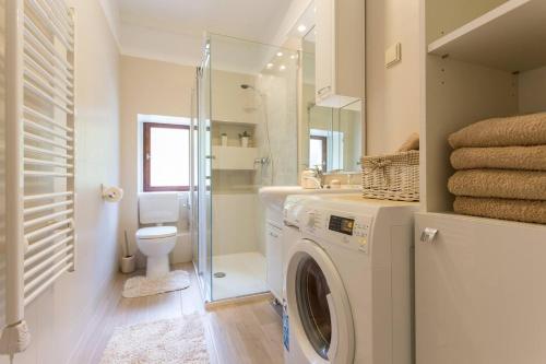 a bathroom with a washing machine and a toilet at Apartments by the sea Dubrovnik - 20309 in Dubrovnik