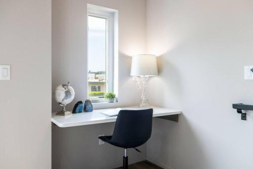 a room with a desk with a chair and a window at *Brand New* Fully Updated Condo 910 in Anacortes in Anacortes