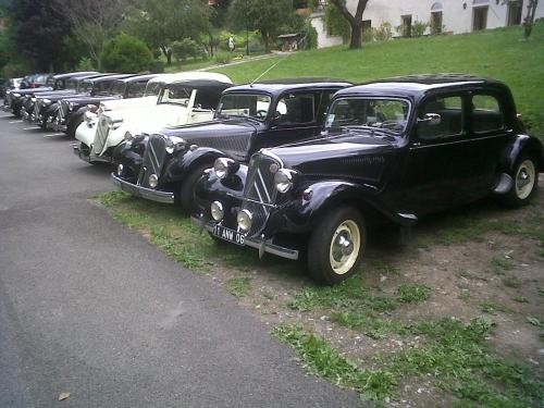 a row of old cars parked on the side of the road at Le Prieuré in Saint-Dalmas-de-Tende