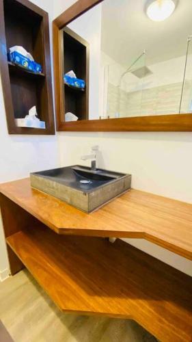a bathroom with a sink and a mirror at Aux vents des rhums au cœur de la Marina du Gosier avec vue imprenable in Pointe-à-Pitre