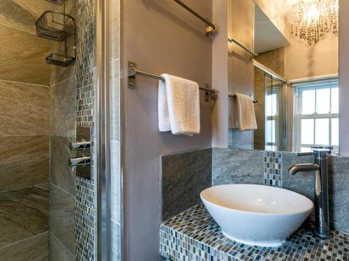 a bathroom with a bowl sink and a shower at Catstycam in Thirlmere