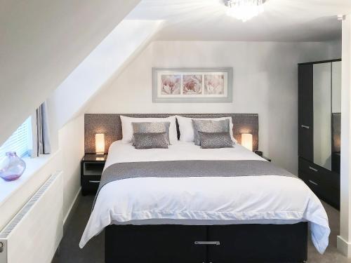 a bedroom with a large bed and a window at Willow Cottage in Great Ryburgh