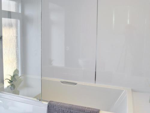 a bathroom with a shower with a glass door at Smithfield House in Tarbolton