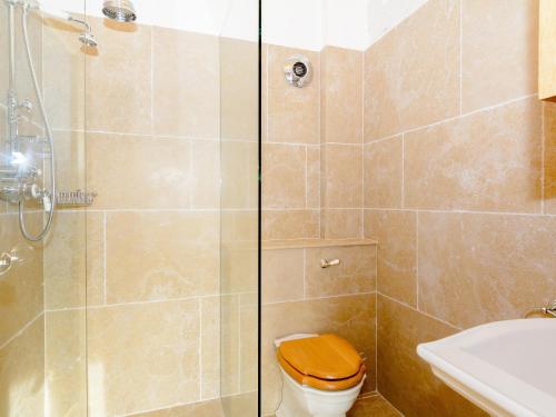 a bathroom with a shower with a toilet and a sink at Bluebell Barn - Uk12792 in Royal Wootton Bassett