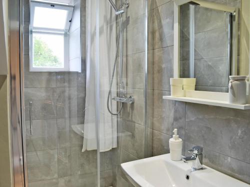 a bathroom with a shower and a sink at Altbeg in Brodick