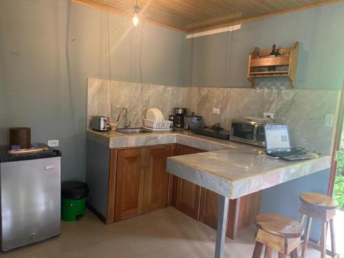 a kitchen with a counter with a laptop on it at La Reina del Mar in Drake