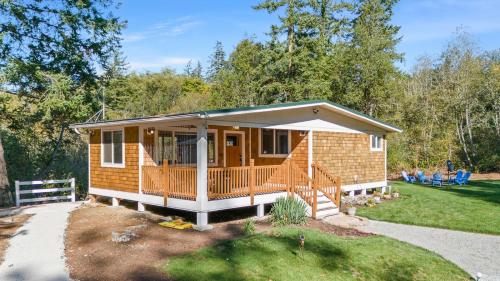 a small house with a porch and a deck at Relajate y recargate de buena vibra en nuestras cabanas de Camano Island in Camano