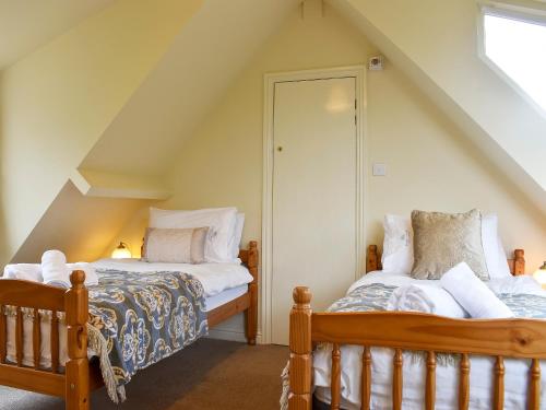 two beds in a room with an attic at Ewden in Robin Hood's Bay