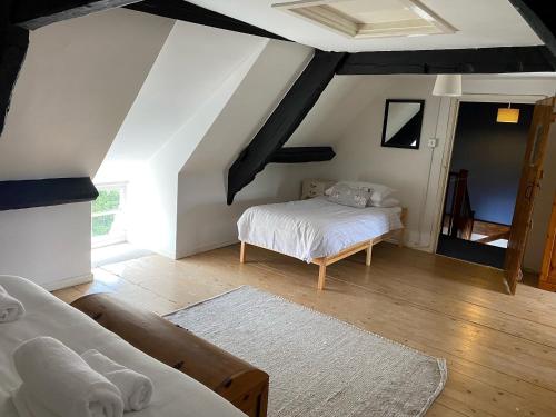 a bedroom with two beds in a attic at Flood House in Bridport
