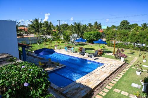 an image of a swimming pool at a resort at Chalés Casuarinas in Japaratinga