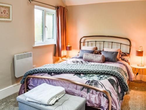a bedroom with a large bed and a window at Brookdale in Malpas