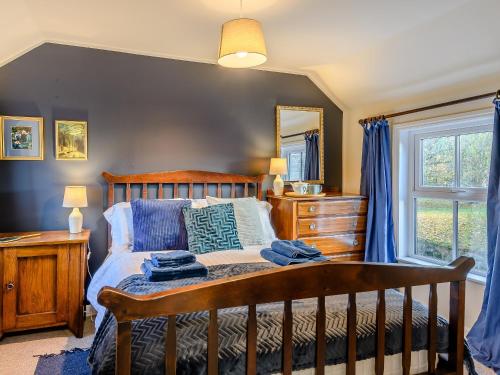 a bedroom with a bed and a dresser and a window at Fair View in Donington on Bain