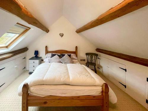 a bedroom with a large bed in a attic at Cefn Y Meirch in Bala