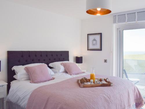 a bedroom with a large bed with a tray on it at The Lookout in Portpatrick