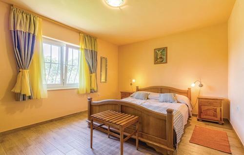 a bedroom with a bed and a chair and a window at Family friendly house with a swimming pool Gajana, Fazana - 15385 in Mednjan