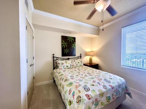 a bedroom with a bed and a ceiling fan at Lovely 22 In Sienna Overlooking The Gulf in Gulfport