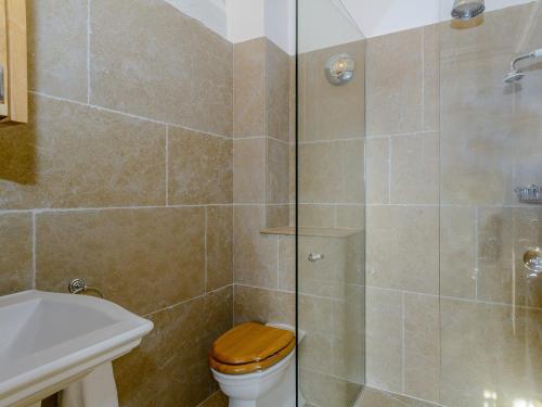 a bathroom with a shower with a toilet and a sink at Buttercup Barn - Uk12963 in Royal Wootton Bassett
