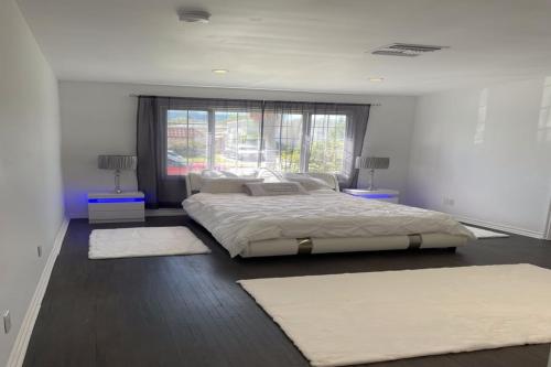 a bedroom with a large bed and two rugs at Stylish Getaway Stay In Beverly Hills in Los Angeles