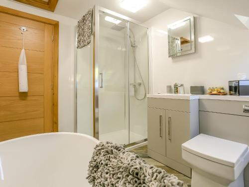 a bathroom with a shower and a toilet and a sink at Beck View in Willoughby