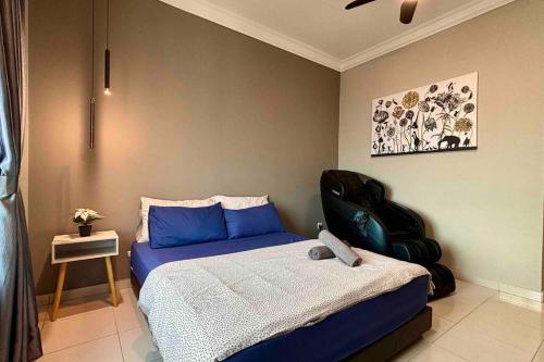 a bedroom with a blue bed and a chair at COZY Modern Spacious 8pax S PICE Penang in Bayan Lepas