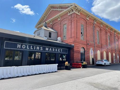 a red brick building with a holis market sign on it at Downtown Private Rooms - Close to M&T, Orioles, Topgolf, Horseshoe Casino in Baltimore