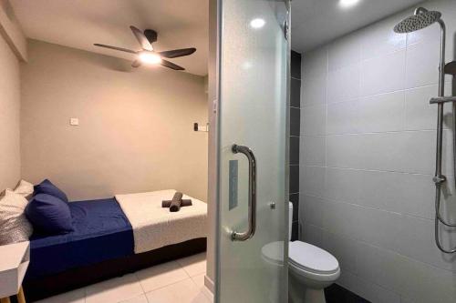 a bathroom with a bed and a shower with a ceiling fan at COZY Modern Spacious 8pax S PICE Penang in Bayan Lepas