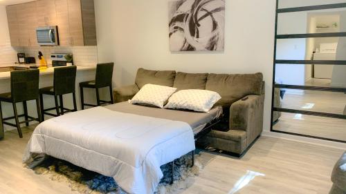 a living room with a bed and a couch at Midtown Atl Gem located 10 minutes from everything! in Atlanta