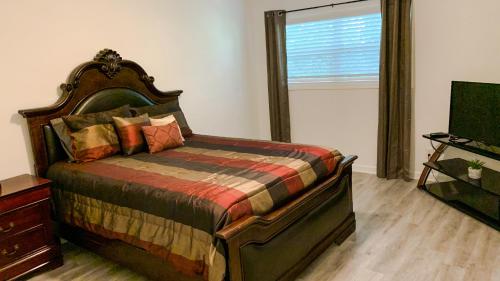 a bedroom with a large bed and a window at Midtown Atl Gem located 10 minutes from everything! in Atlanta