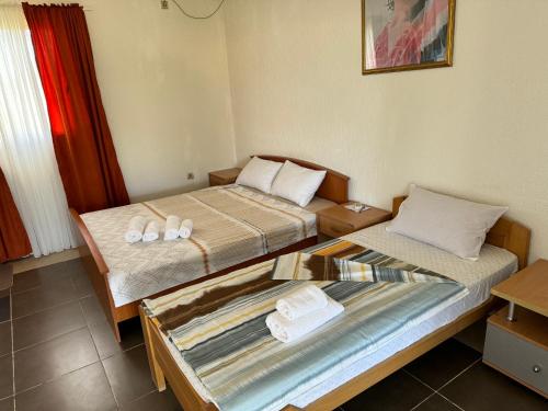 a room with two beds with towels on them at Apartments Airport Golubovci 2 in Podgorica
