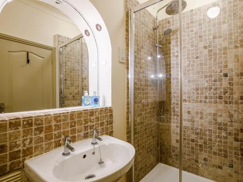 a bathroom with a sink and a shower at Ladybird Cottage in Hunstanton