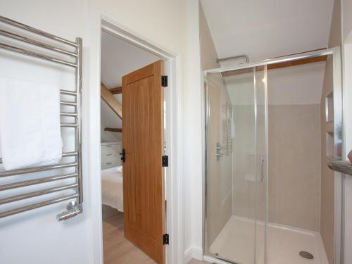 a bathroom with a shower and a glass door at The Shippon - Uk37467 in Berrynarbor