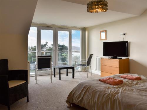 a bedroom with a bed and a flat screen tv at Bay View in Carlyon Bay