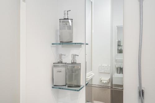 a bathroom with two soap dispensers on a shelf at ZAITO Tokyo Skytree Yokokawa III 錦糸町駅から徒歩９分 in Tokyo