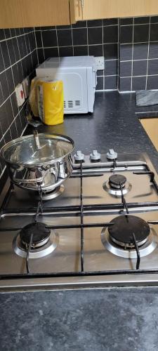 a stove top with a pan on top of it at 13 Decent Homes in Dukinfield