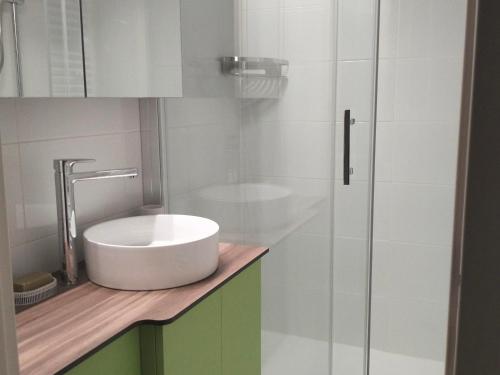 a bathroom with a sink and a glass shower at Appartement Corrençon-en-Vercors, 2 pièces, 4 personnes - FR-1-761-10 in Corrençon-en-Vercors