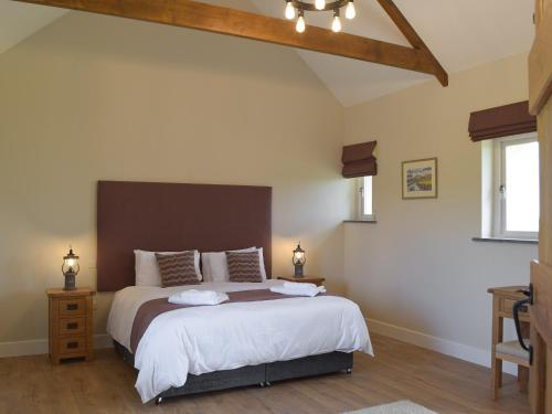 a bedroom with a large bed in a room at Bwthyn Y Bugail in Abercych