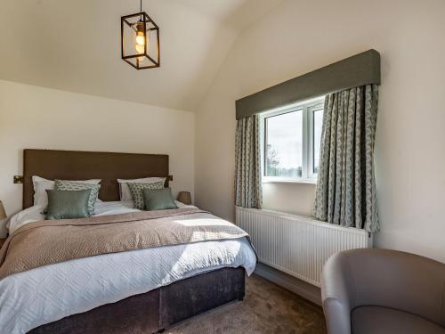 a bedroom with a bed and a window at Copper House in Willoughby