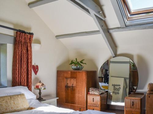 a bedroom with a bed and a mirror at The Old Chapel in Washaway