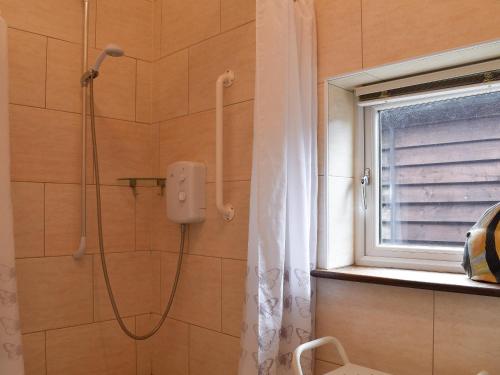 a shower in a bathroom with a shower curtain at Willow in Harrietsham