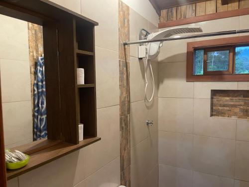 a bathroom with a shower with a shower head at Hostería CASA SAN LUIS in Mindo
